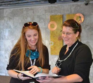 Mk Haley, at right, consults with Kristin Roberts